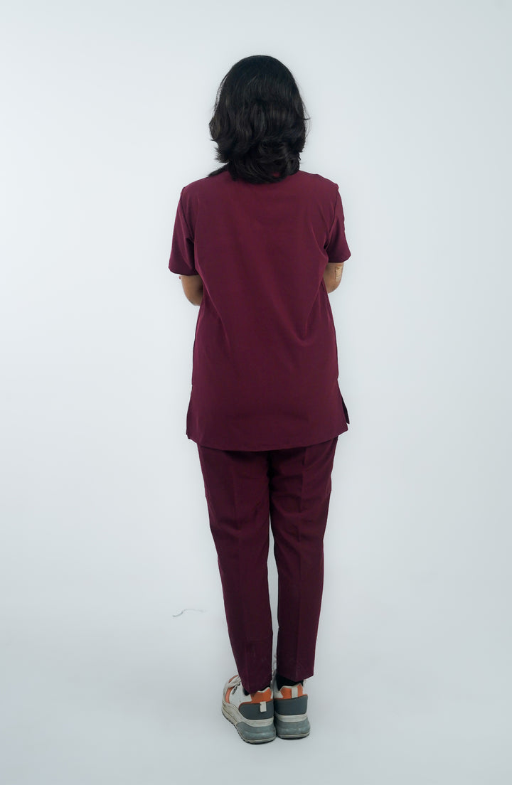 Rear view of a female model in tailored scrubs emphasizing comfort and elegance.