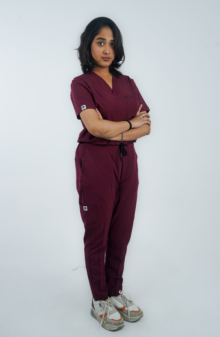 Female nurse showing side profile in ScrubyHub’s form-fitting maroon scrubs.