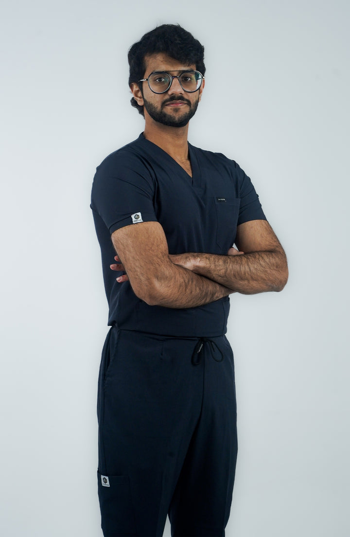 Side angle of male nurse highlighting comfort fit of Midnight Ocean Wave Scrubs – ScrubyHub.