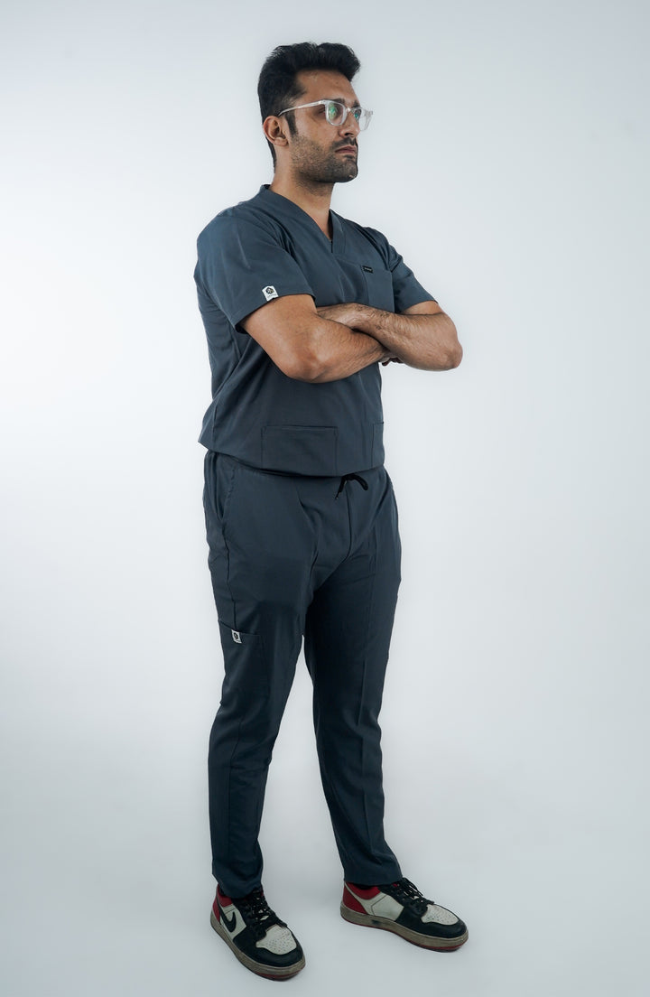 standing side angle of male medical professional in modern slate gray scrubs.