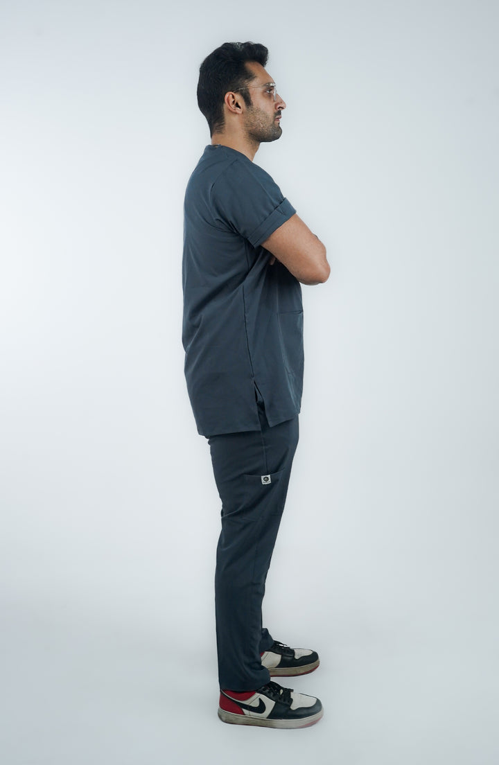 Side angle of male medical professional in modern slate gray scrubs.