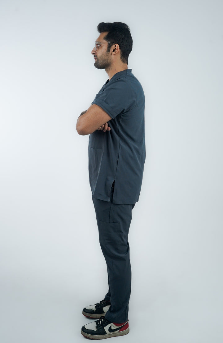 Side profile of male healthcare worker in sleek slate gray medical scrubs.
