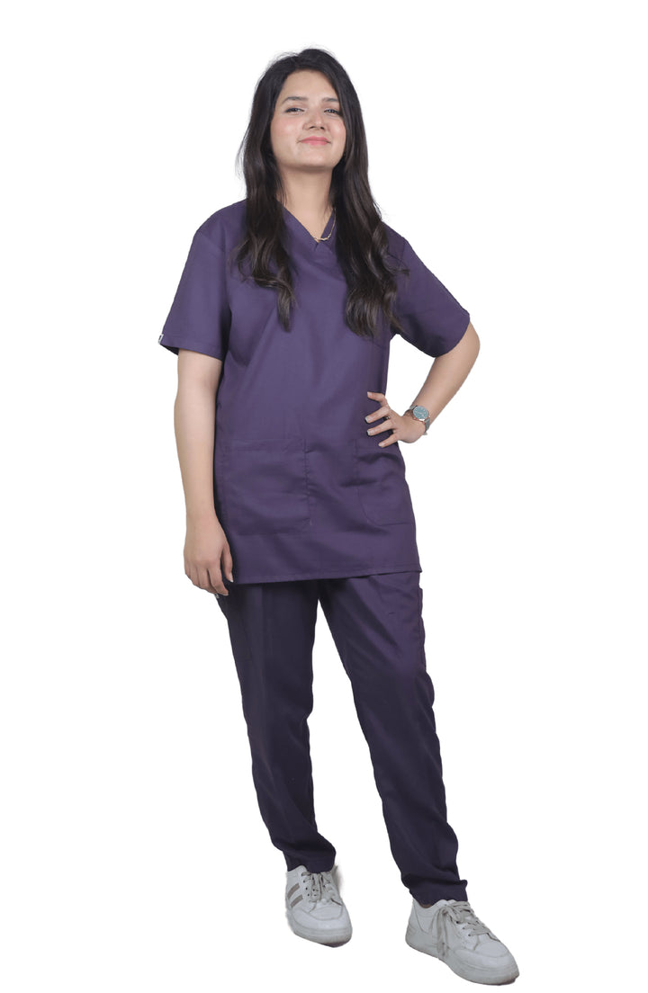 Female nurse in ScrubyHub purple cotton scrub posing front-facing with a soft smile.