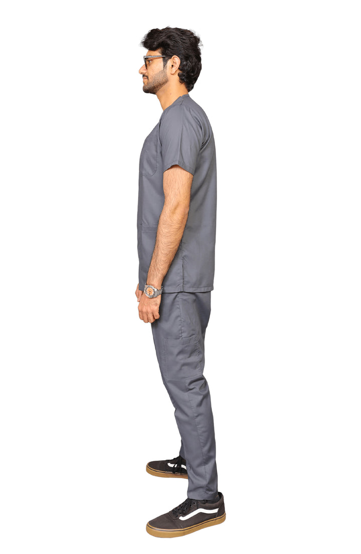 Side view of male doctor in breathable green scrub from ScrubyHub, standing in clinic