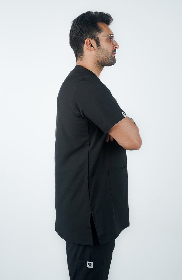 side profile of young male doctor wearing midnight black charm scrub 