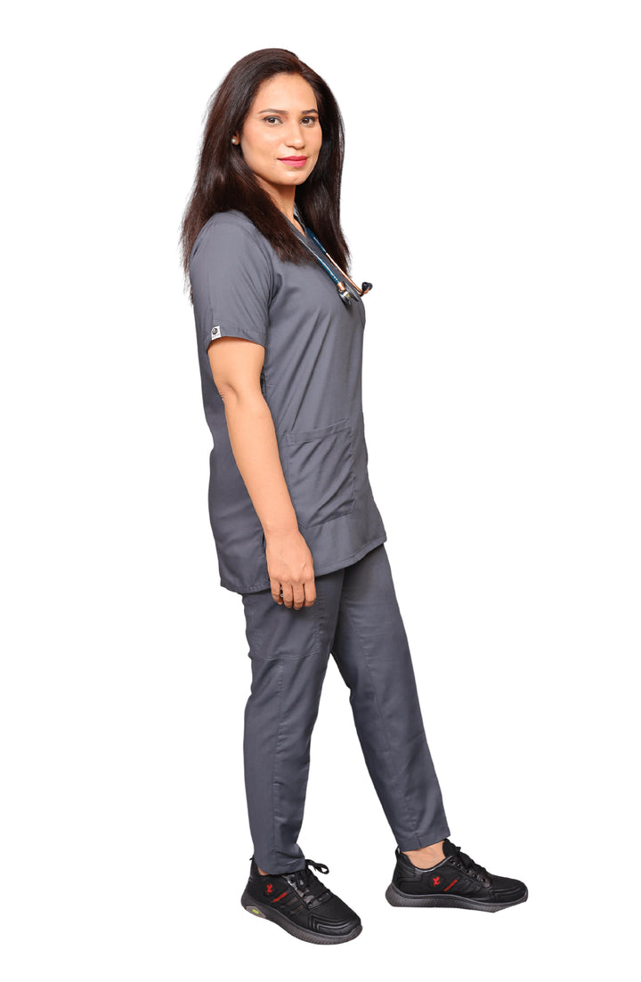 Female nurse in grey cotton scrub by ScrubyHub, smiling in clinical setting